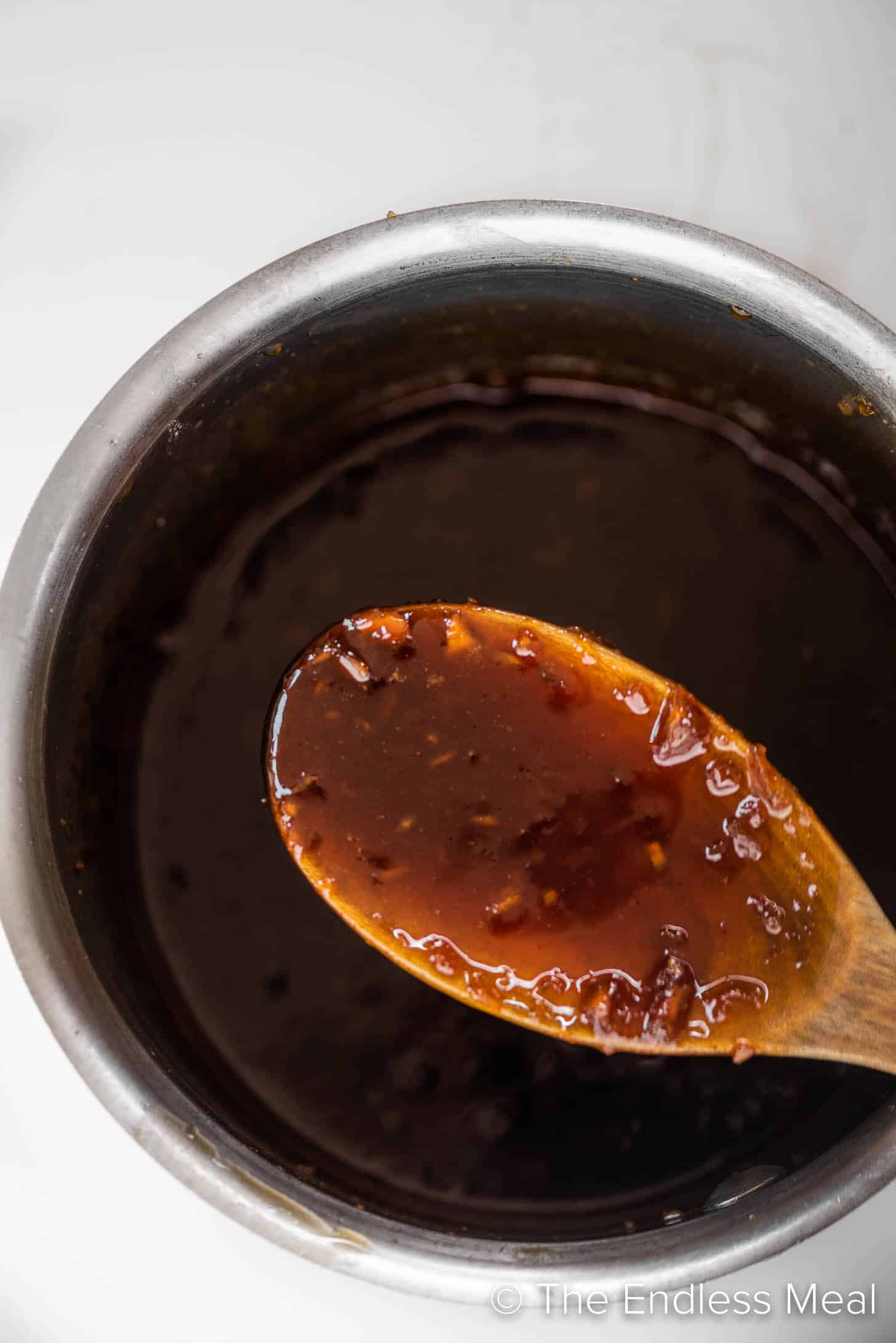 Honey Garlic Sauce in a pot with a wooden spoon