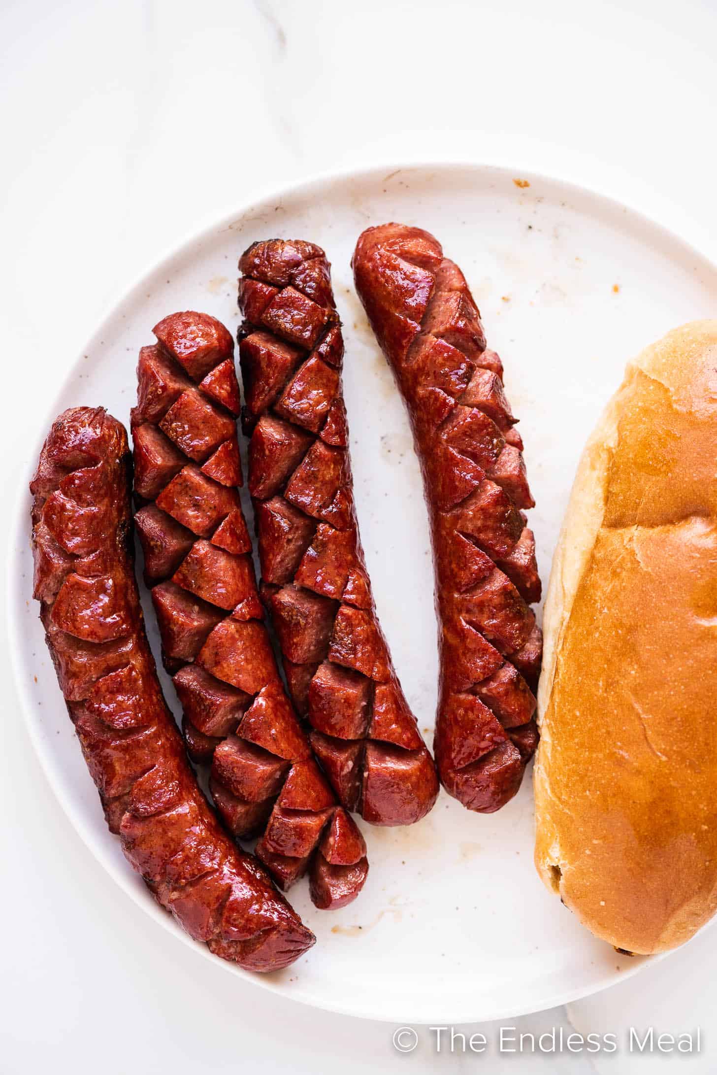 grilled hot dogs and buns on a plate
