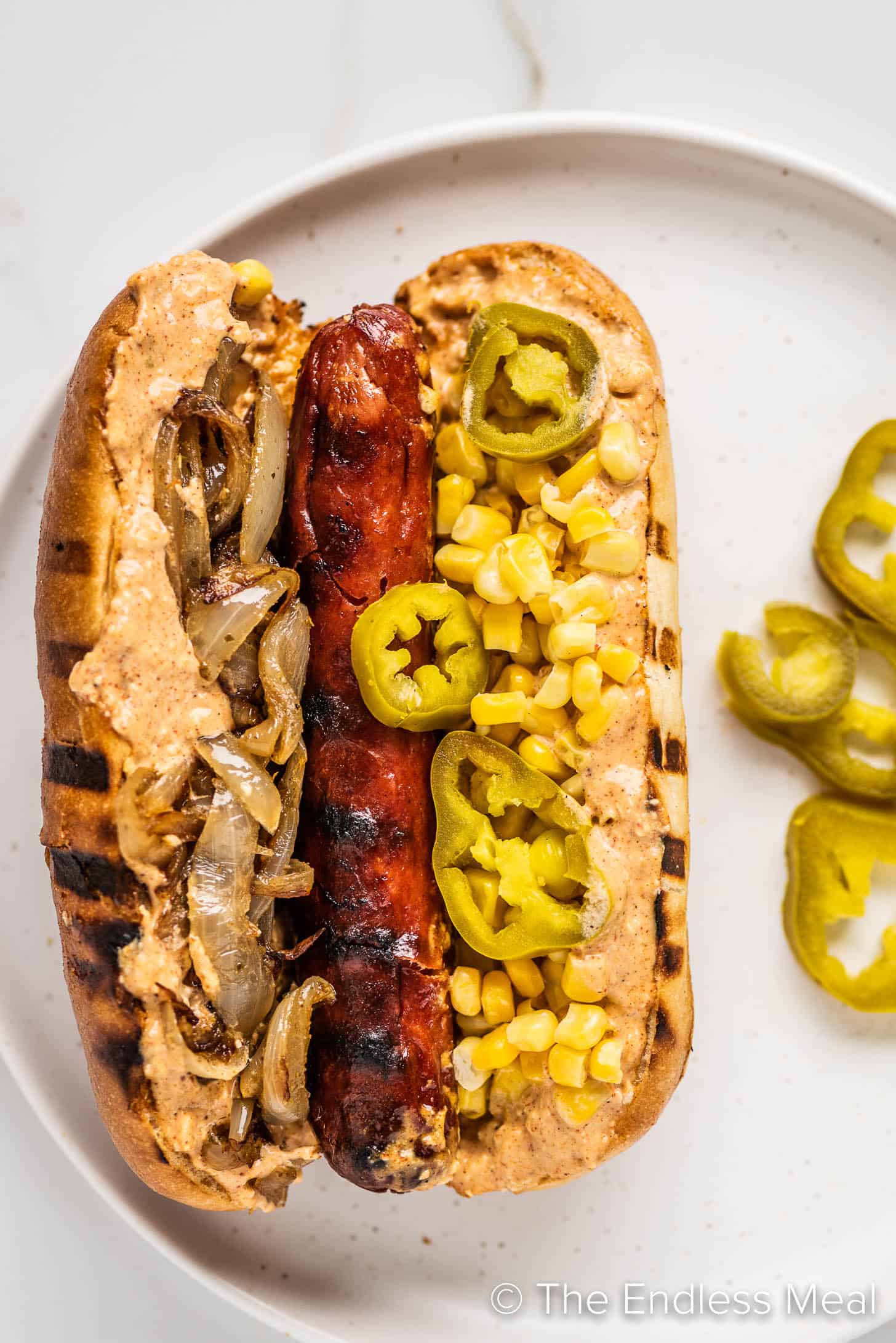 a hot dog with mexican flavors on a plate