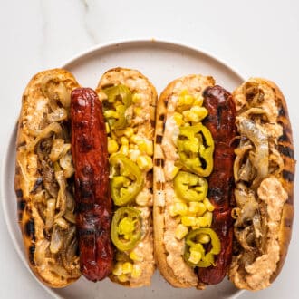 two Mexican Hot Dogs on a white plate