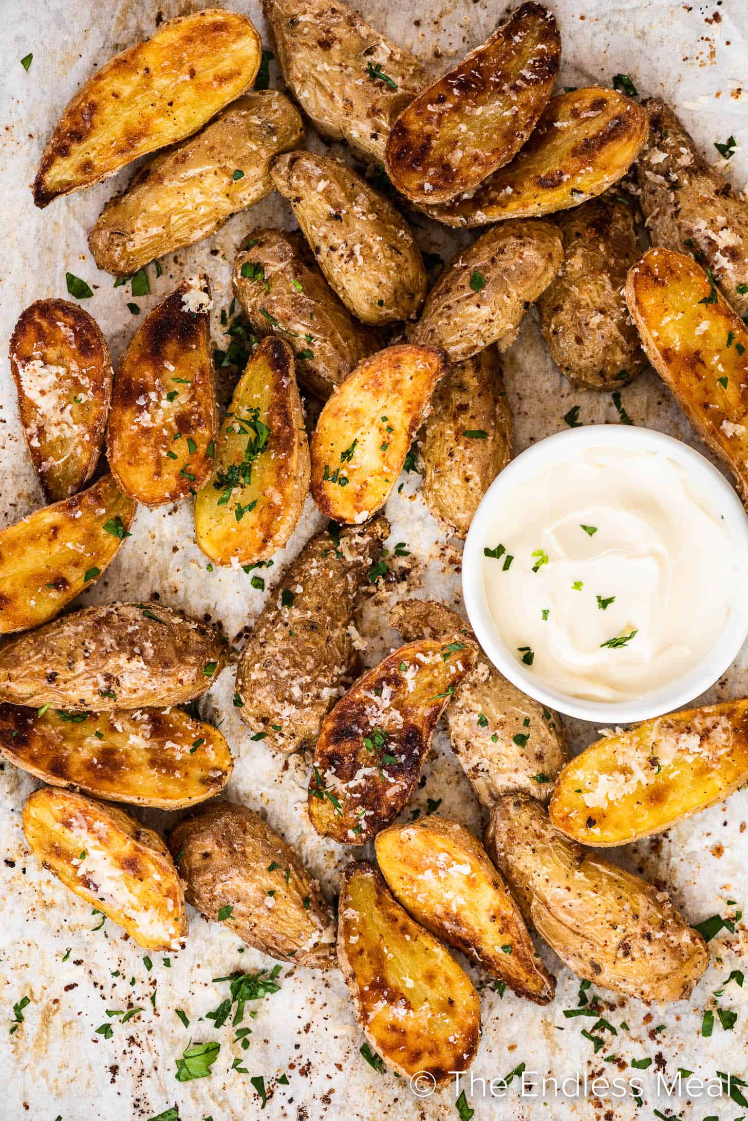 Roasted Fingerling Potatoes on a baking sheet with a side of mayo