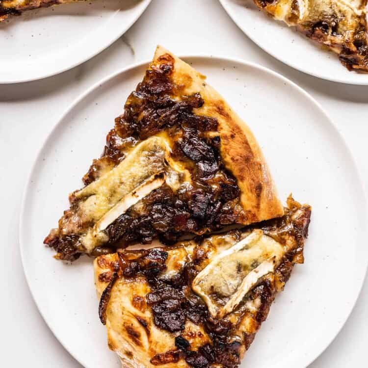 two pieces of pizza with bacon jam on a plate