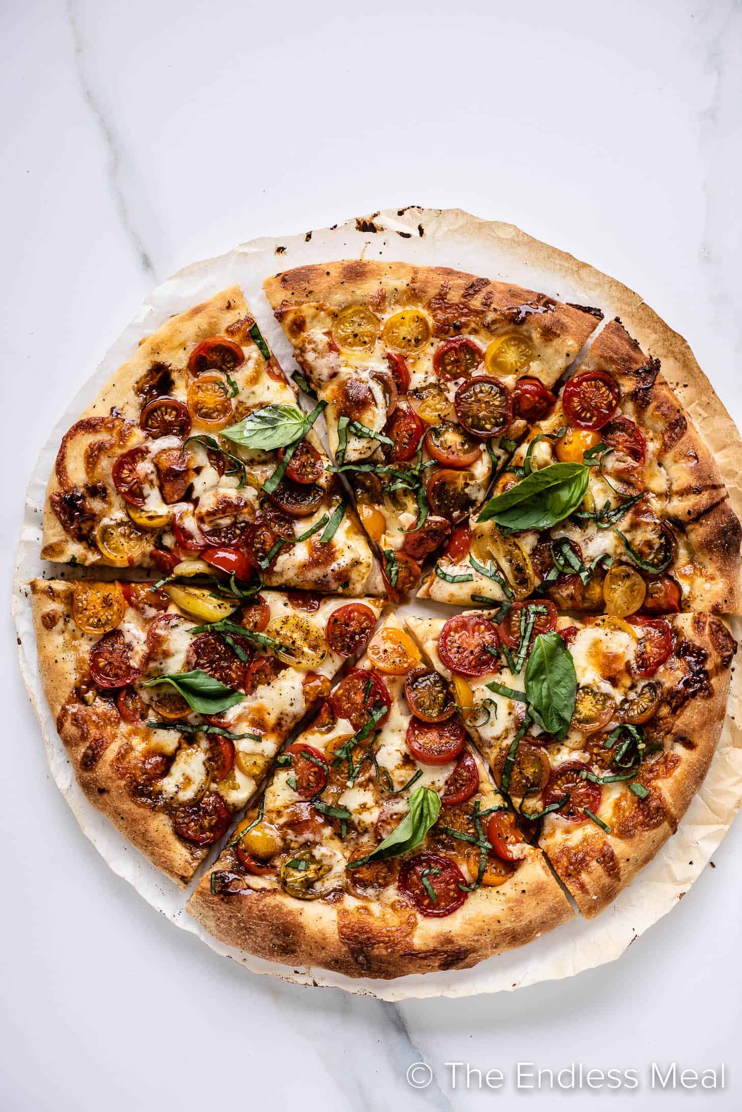 a Caprese Pizza sliced into 6 pieces