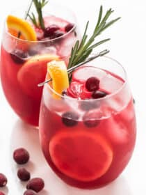 2 glasses of Cranberry Lemonade with orange and rosemary