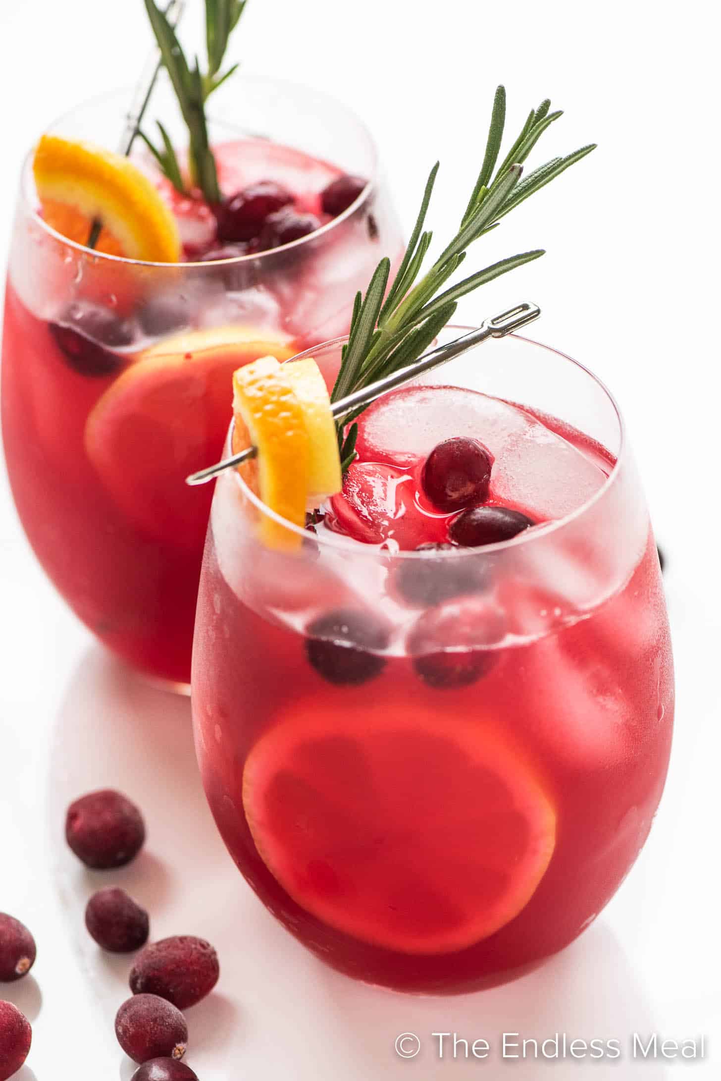 2 glasses of Cranberry Lemonade with orange and rosemary