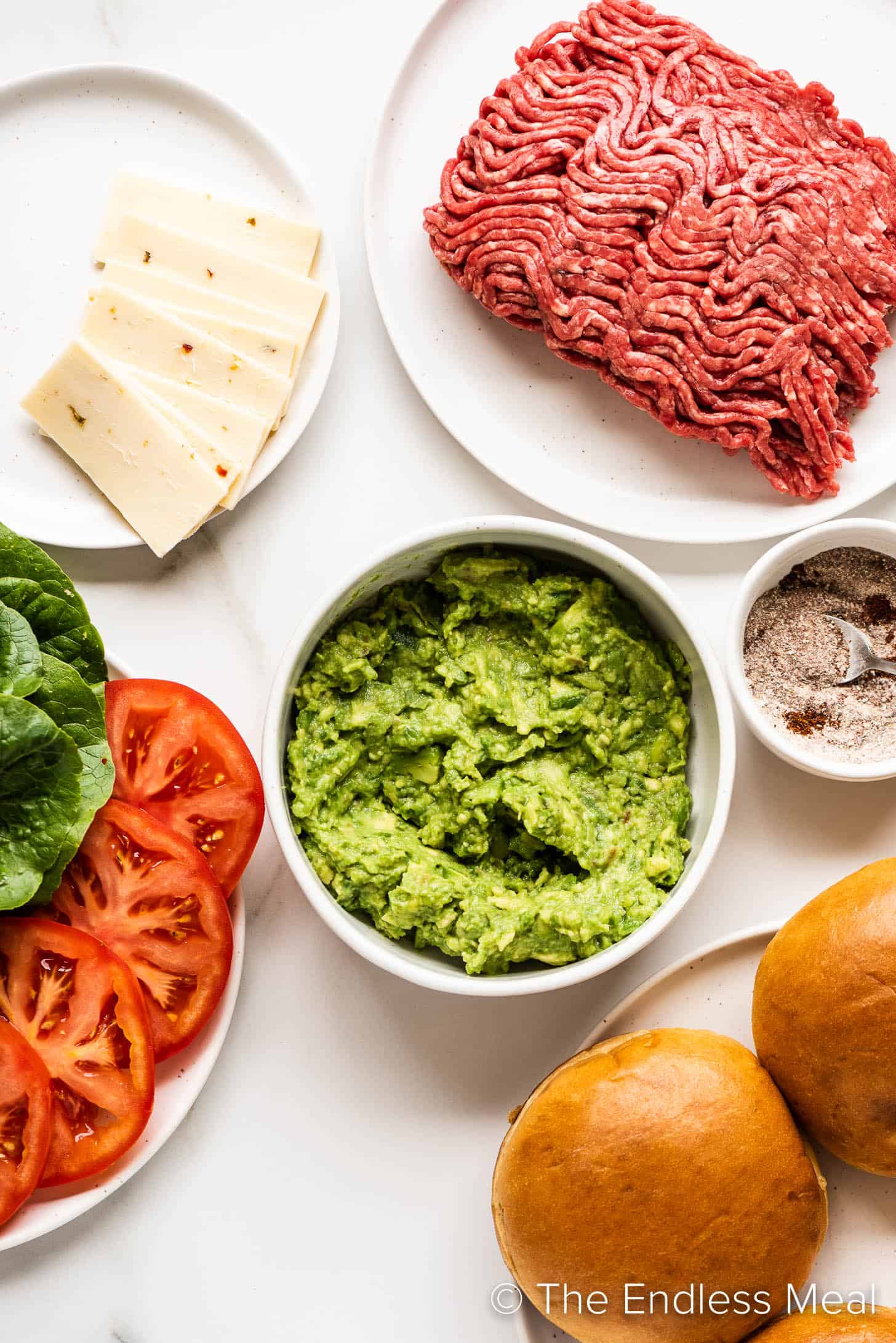 all the ingredients needed to make a burger with guacamole