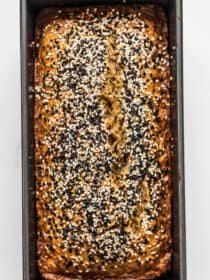 looking down on a loaf of Tahini Banana Bread topped with sesame seeds