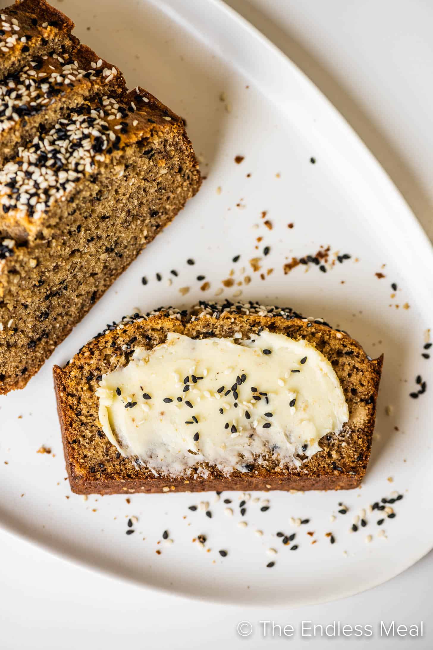 a buttered slice of Tahini Banana Bread on a plate