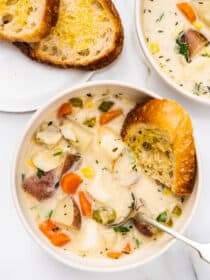 fish chowder in a bowl with bread