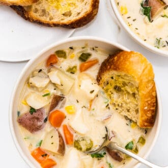 fish chowder in a bowl with bread