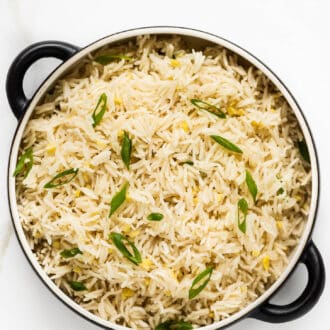 Ginger Rice in a serving dish with the recipe title on top of the picture.