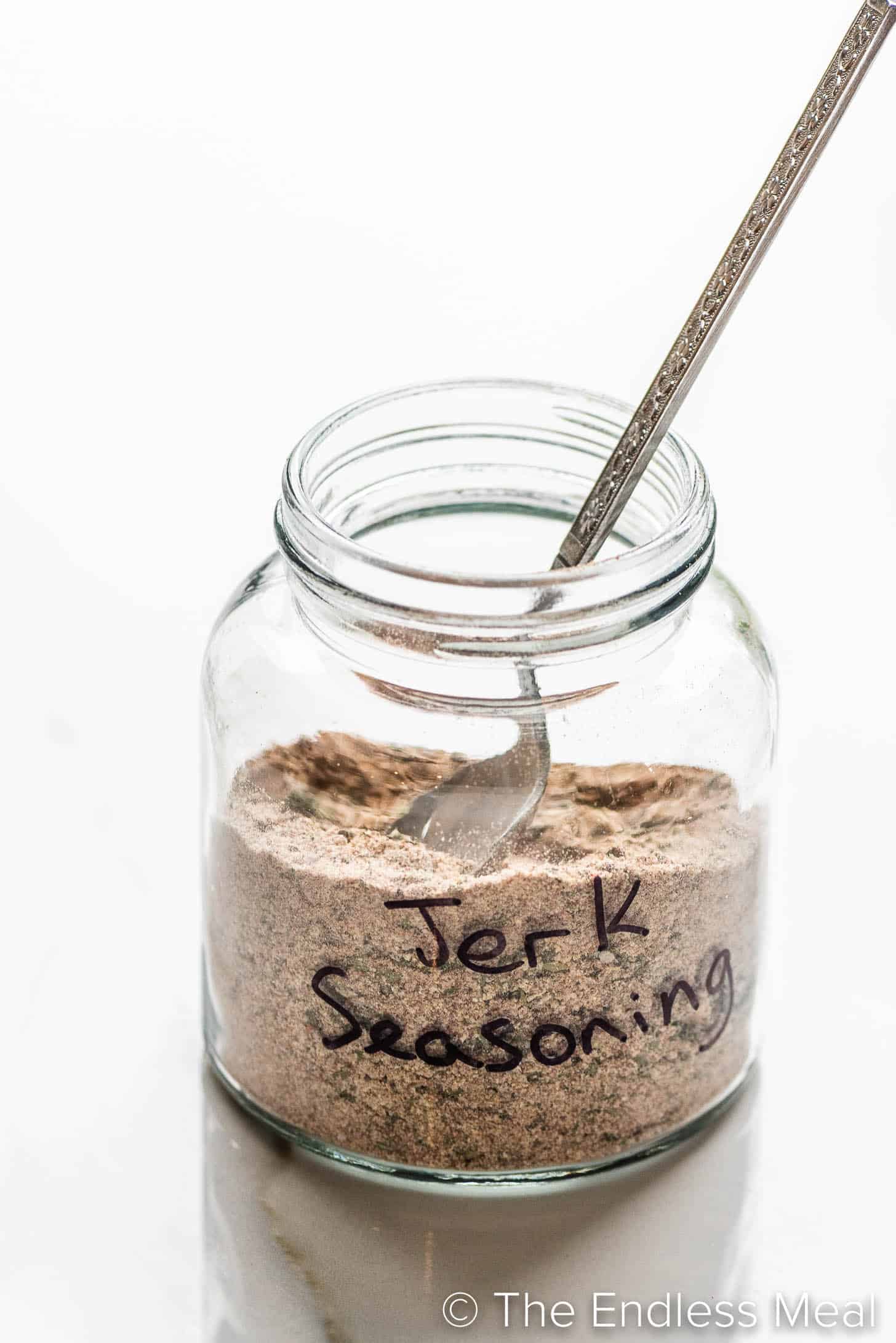 a glass jar labeled jerk seasoning