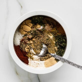 the spices needed to make this jerk seasoning recipe being mixed in a bowl