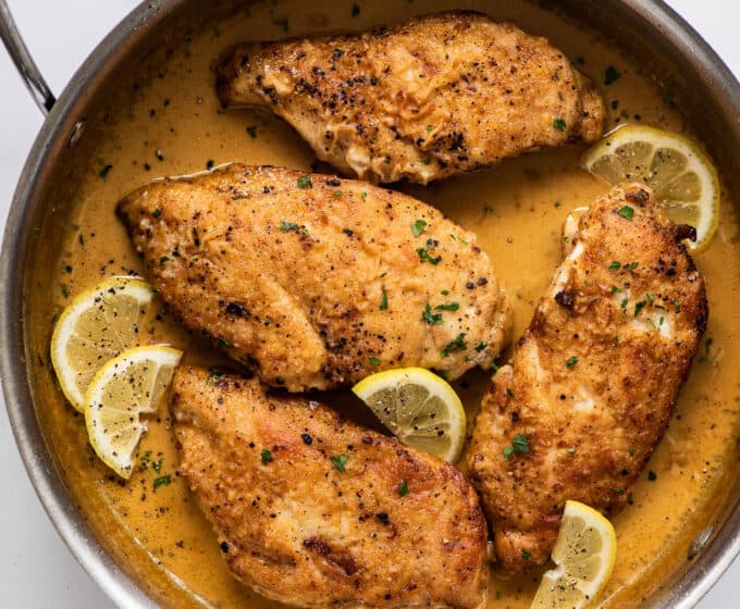Lemon Pepper Chicken in a frying pan with a creamy sauce