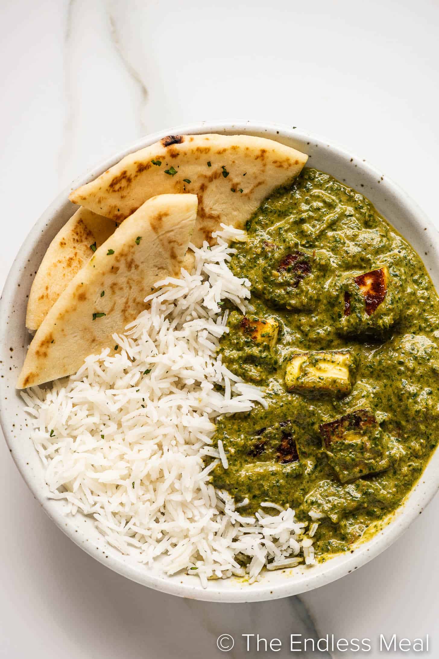 a close up of Palak Paneer (spinach curry) in a bowl