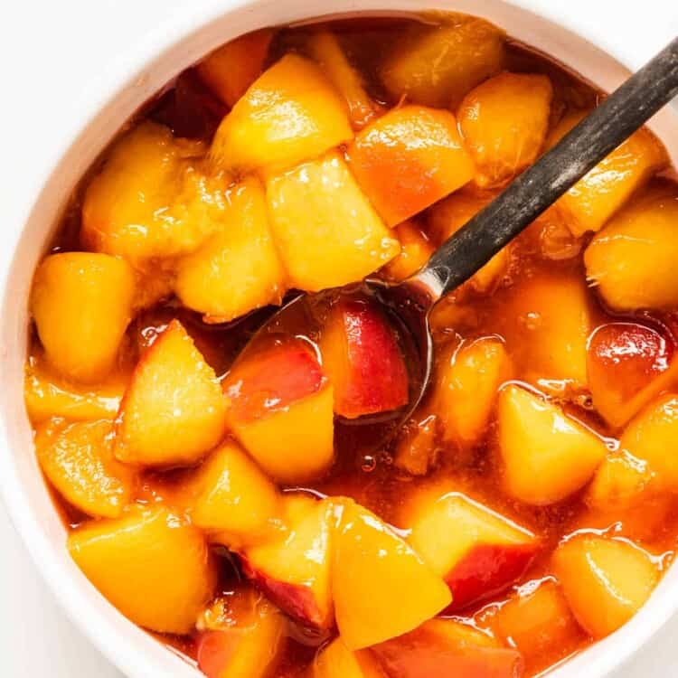 Peach Compote in a bowl with a spoon