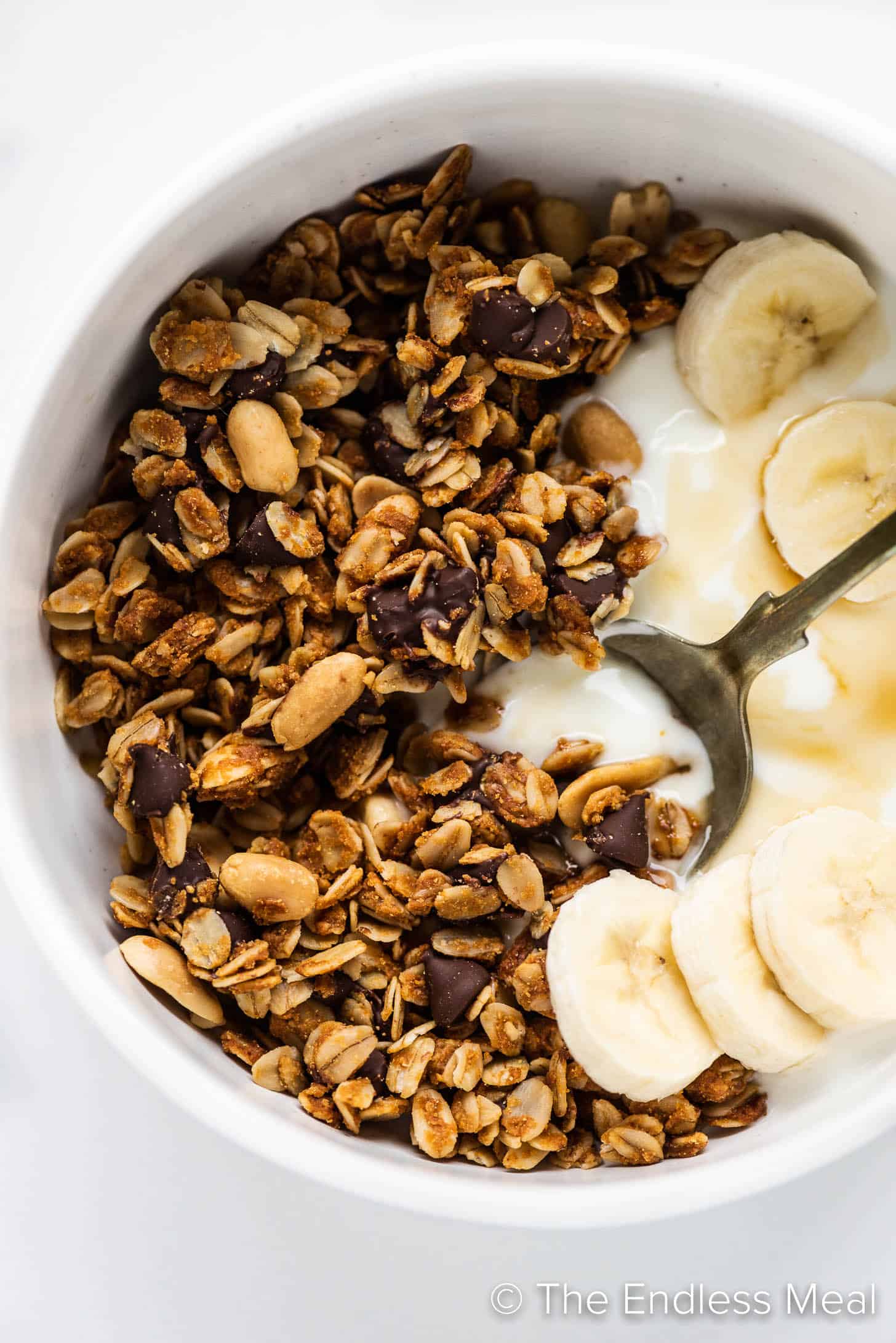 Peanut Butter Granola in a bowl with yogurt and banana slices
