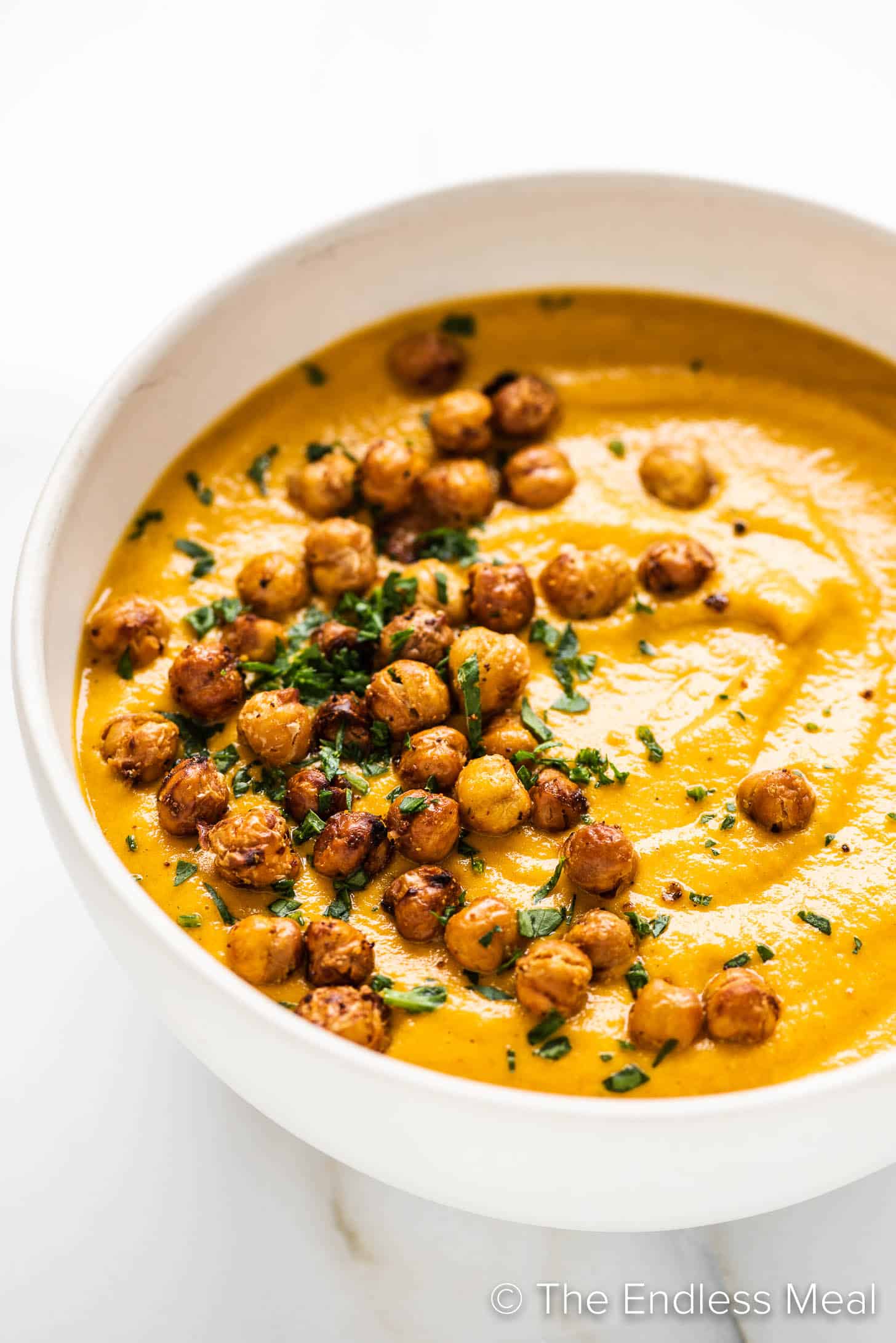 a white bowl with Roasted Carrot Soup