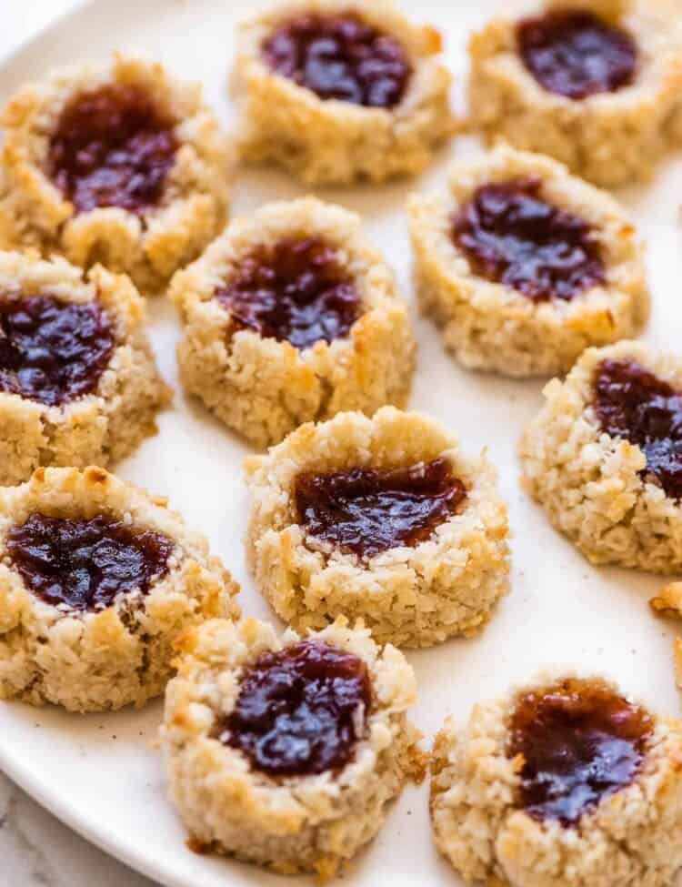 a close up of Coconut Thumbprint Cookies (macaroons!) on a serving plate.