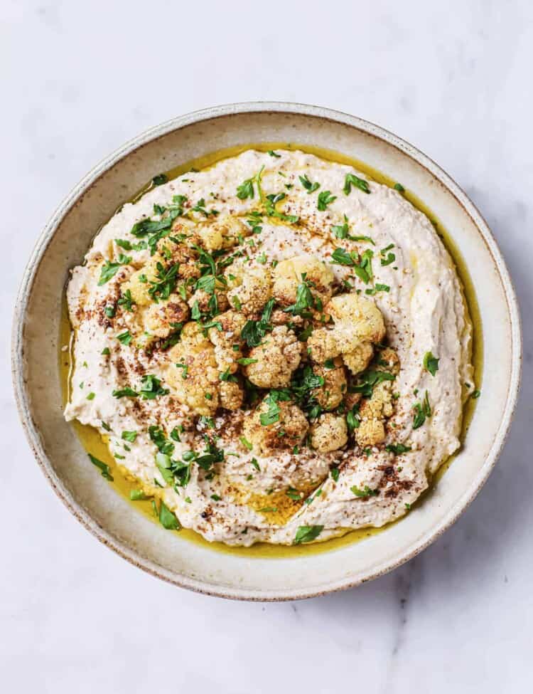Cauliflower Hummus in a bowl topped with roasted cauliflower
