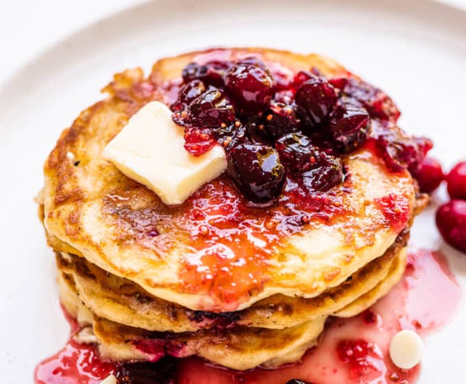 a stack of Cranberry Pancakes on a white plate