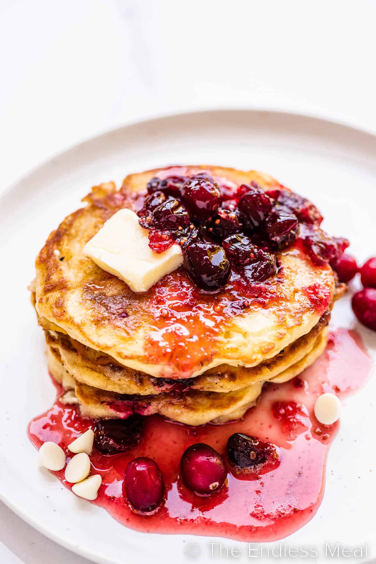 a stack of Cranberry Pancakes on a white plate