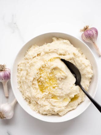 Garlic Parmesan Mashed Potatoes in a bowl with a serving spoon