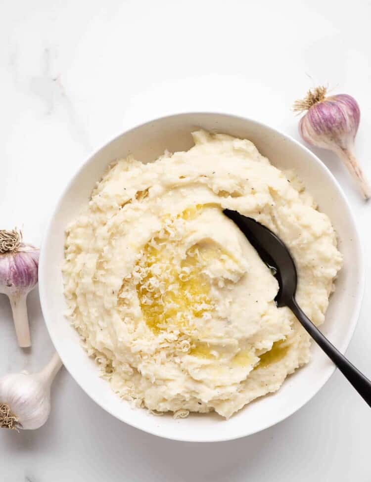 Garlic Parmesan Mashed Potatoes in a bowl with a serving spoon