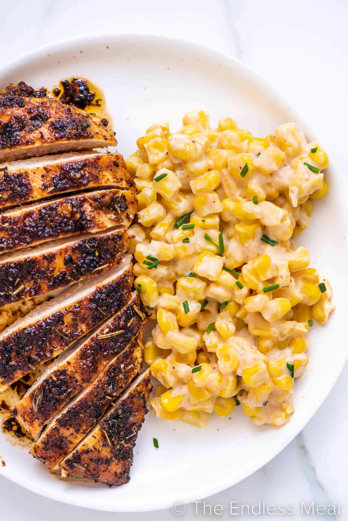 Honey Butter Skillet Corn on a plate next to chicken