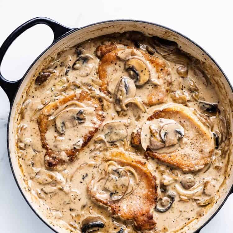 Smothered Pork Chops with Mushroom Onion Gravy in a pan
