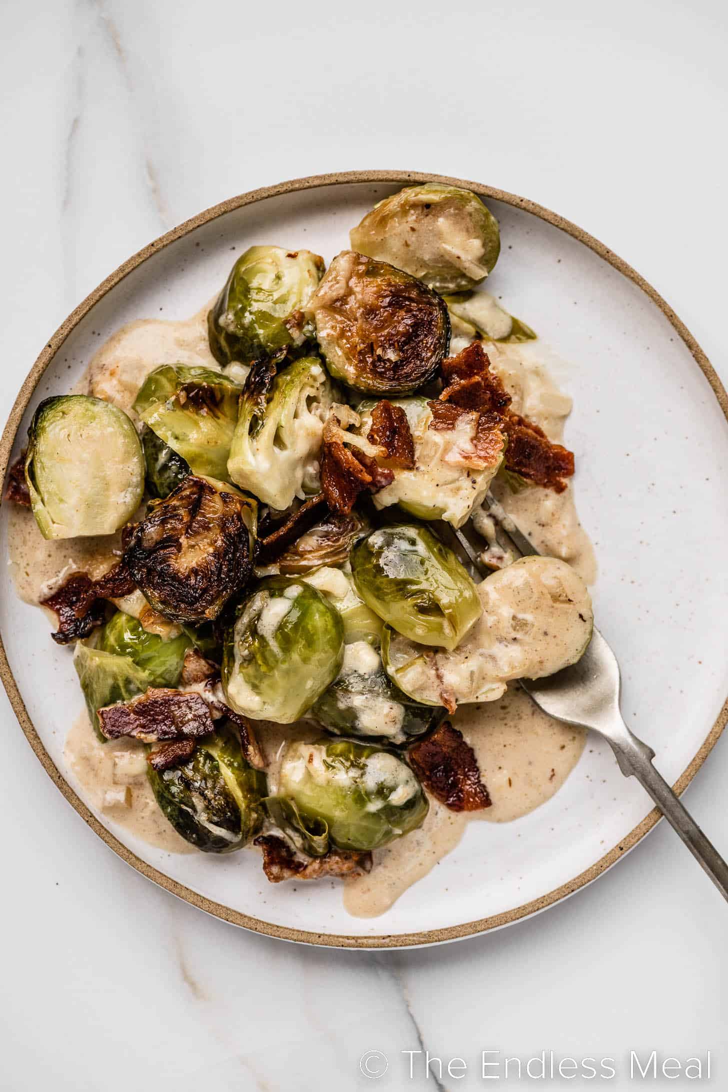 Brussels Sprouts au Gratin on a plate with a fork