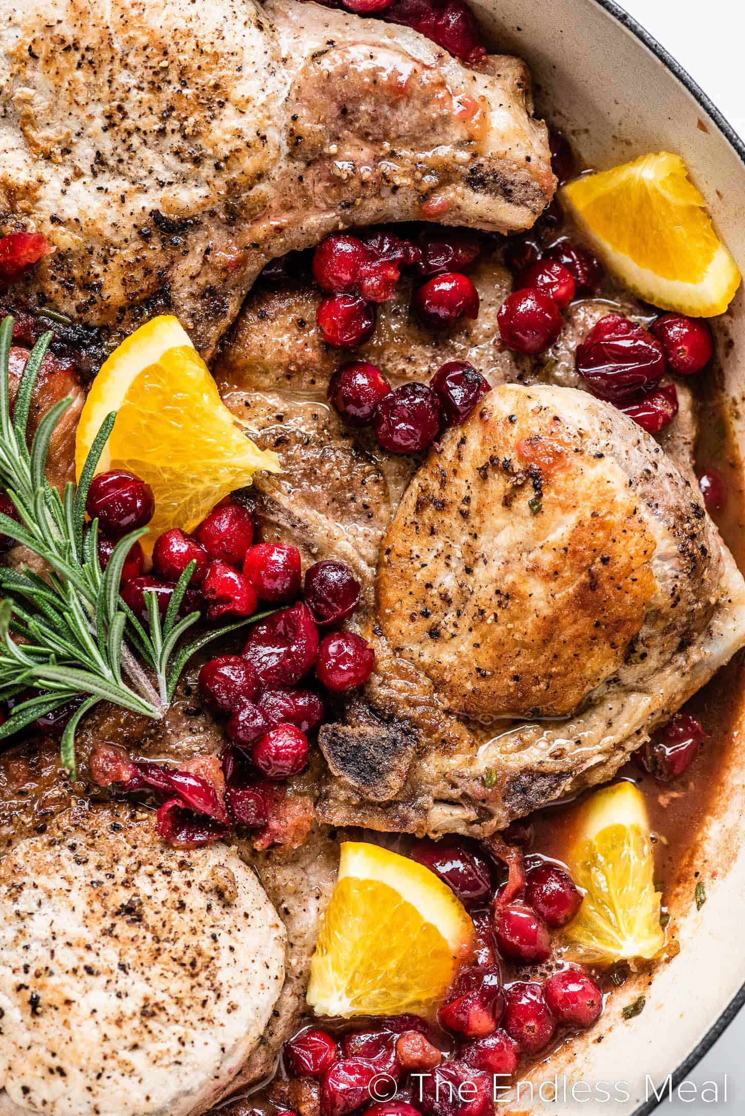 a close up of Cranberry Pork Chops in a pan