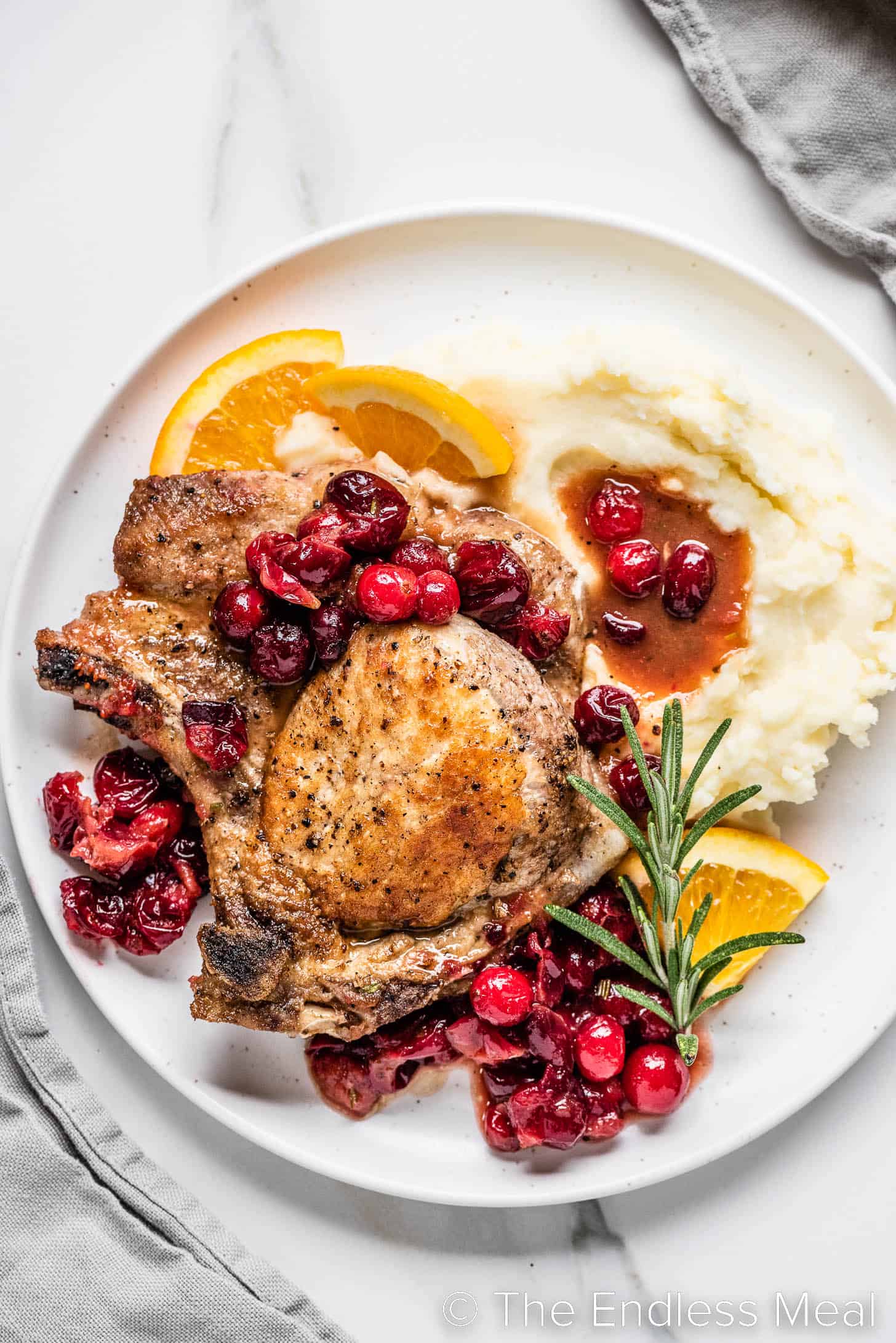a plate of pork chops with cranberry sauce