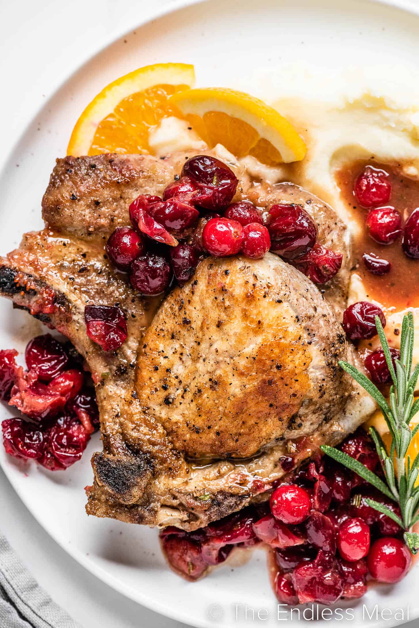 Cranberry Pork Chops on a plate with mashed potatoes