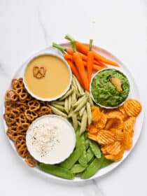 Three Easy Party Dips on a tray with chips and veggies