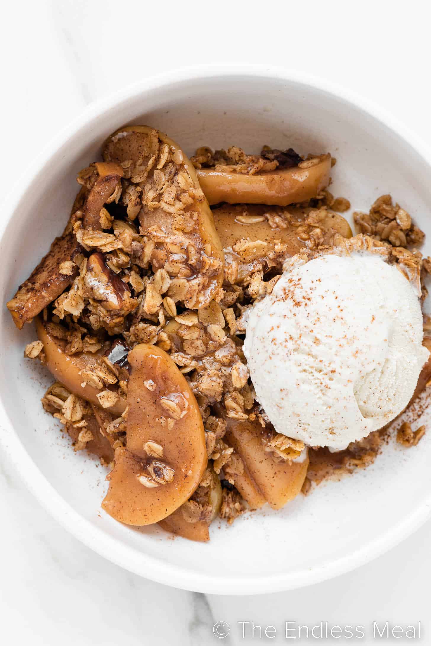 a close up of Healthy Apple Crisp with ice cream.