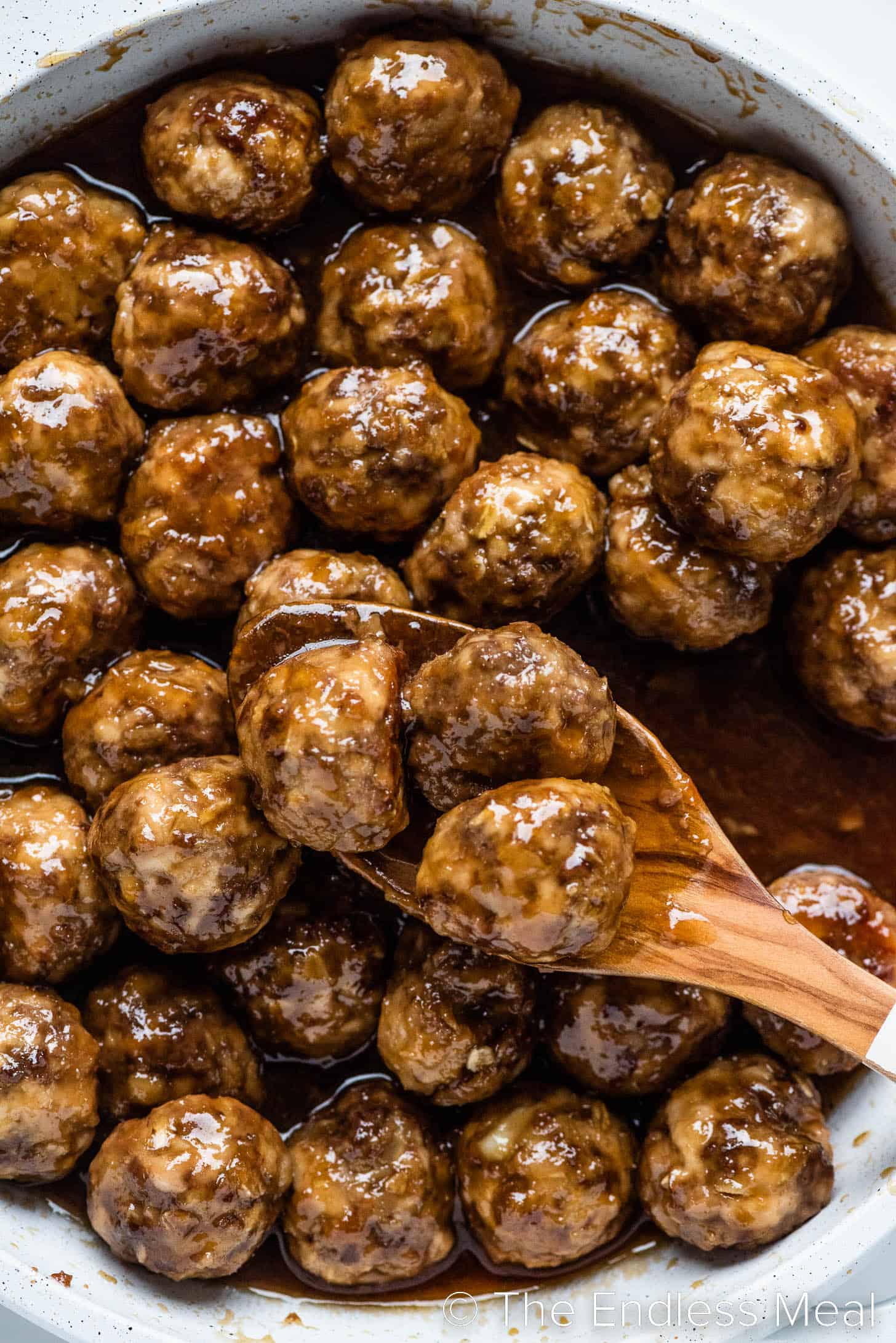 a close up of meatballs in a honey garlic sauce in a pan