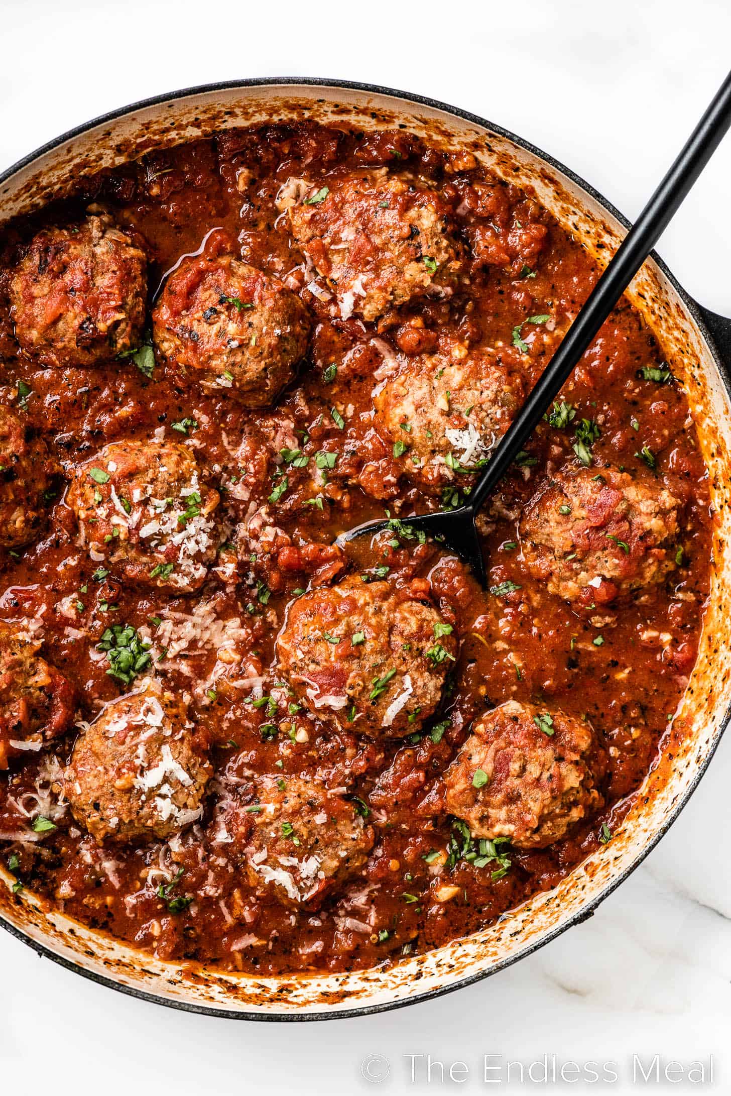 Meatballs in Tomato Sauce in a pot with a spoon