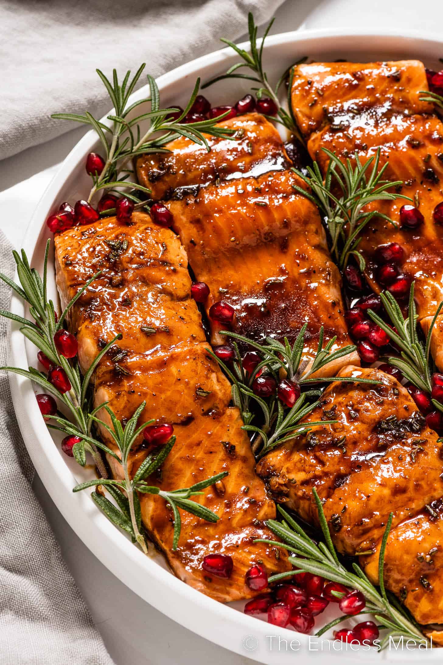 Christmas Salmon with maple pomegranate glaze on a holiday serving plate.