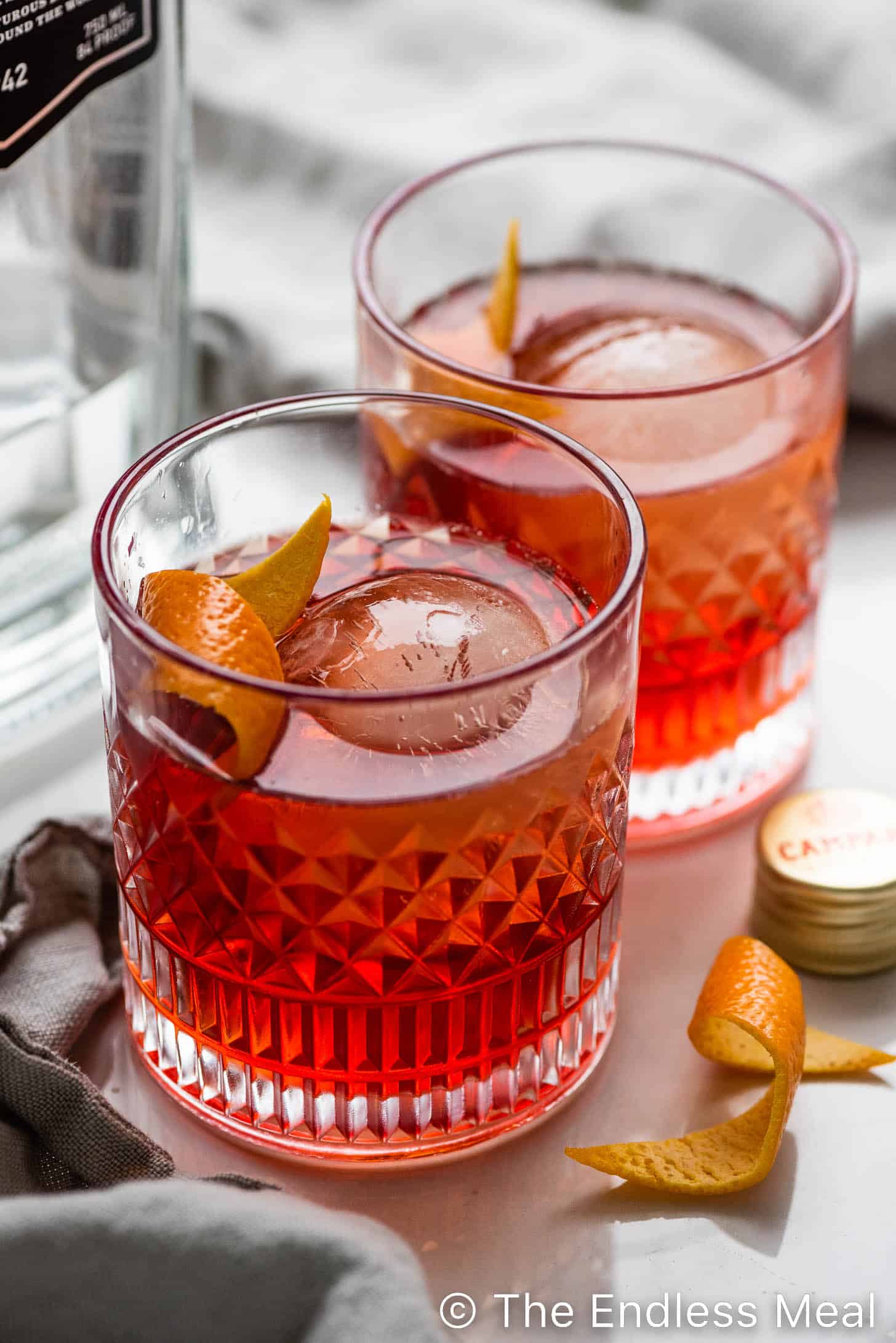 two negronis with an orange twist