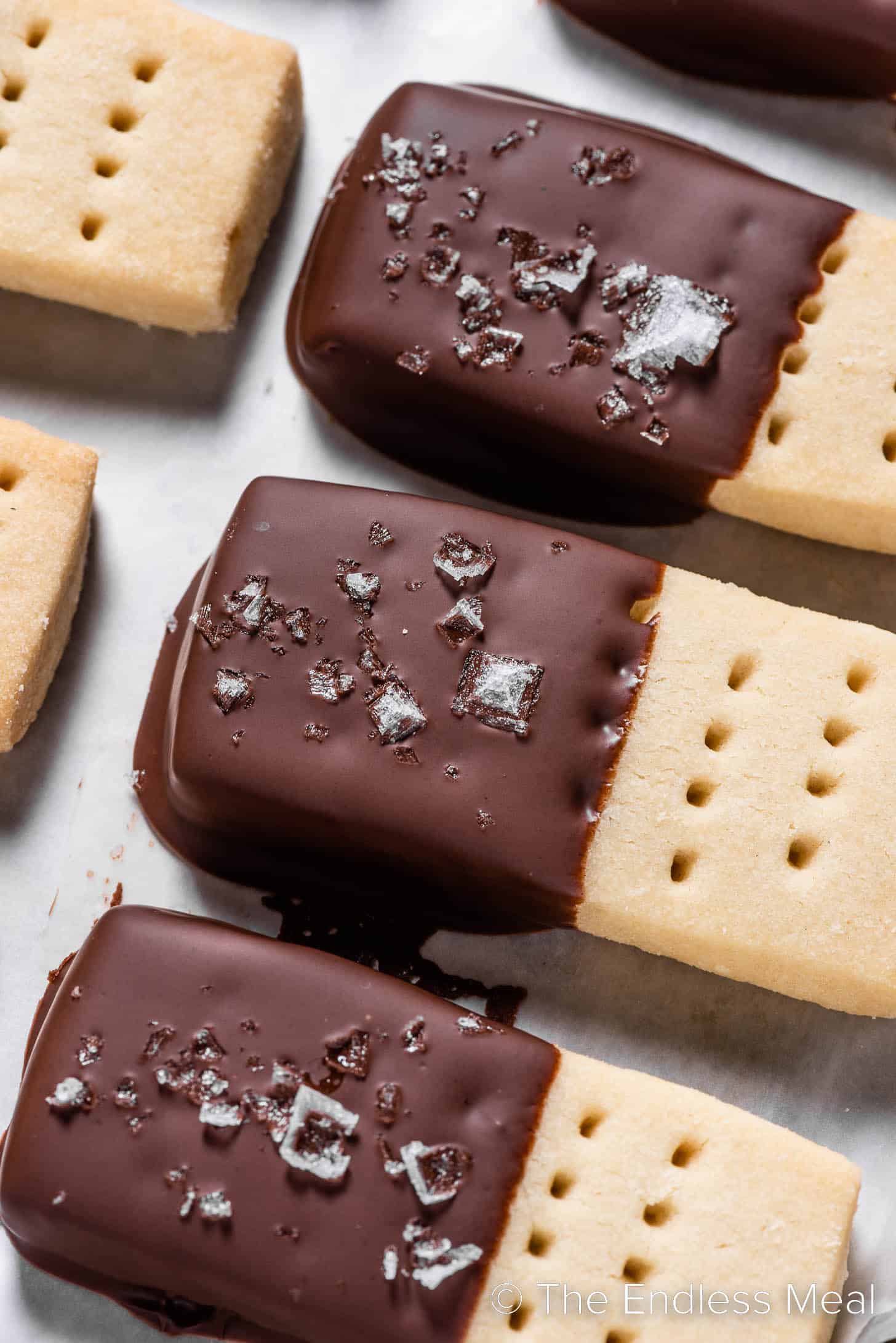 A close up of shortbread cookies dipped in chocolate