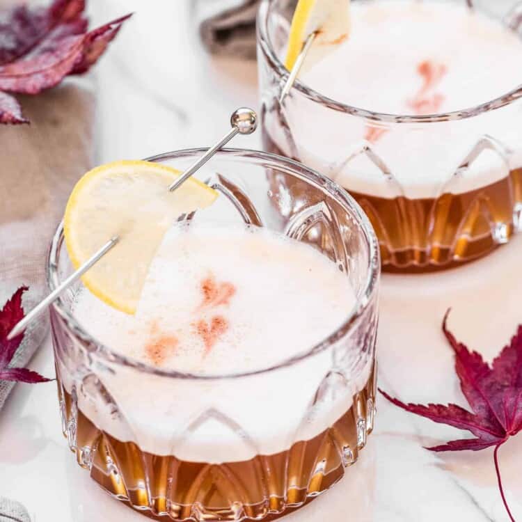 Two Maple Bourbon Sours surrounded by maple leaves