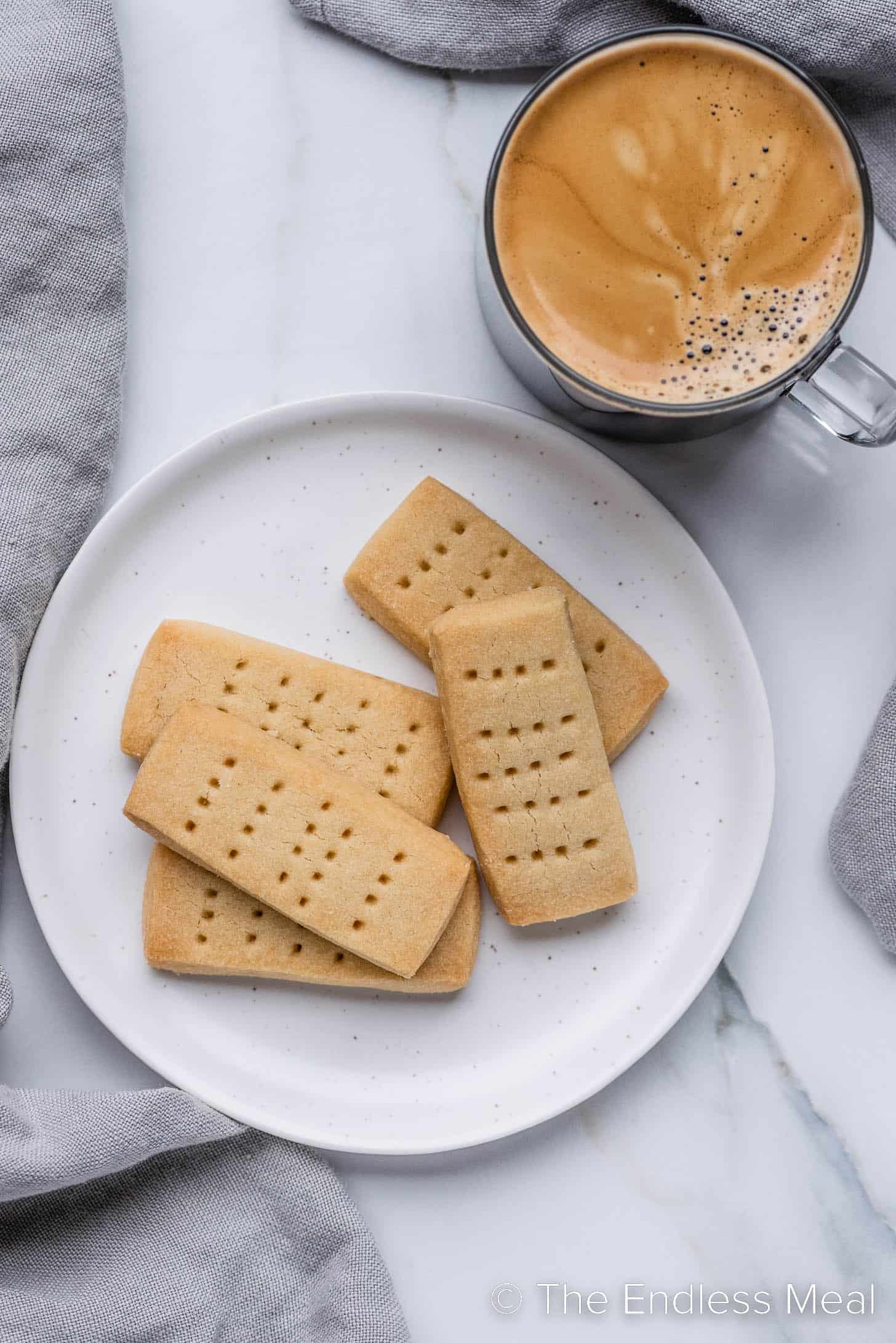 Scottish Shortbread on a plate beside a cup of coffee