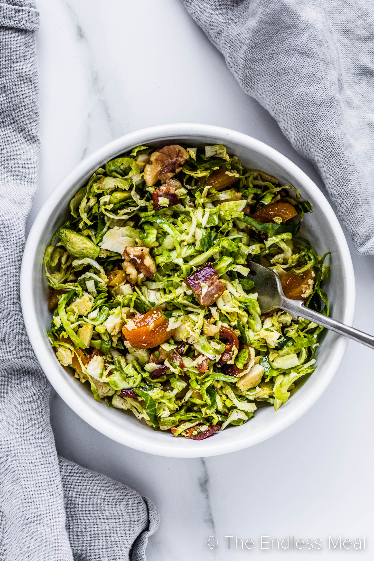 Shredded Brussels Sprouts Salad in a bowl with a fork
