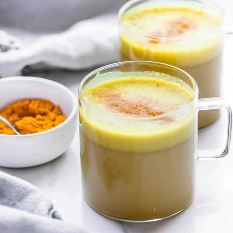 Two Coconut Turmeric Lattes in glass mugs