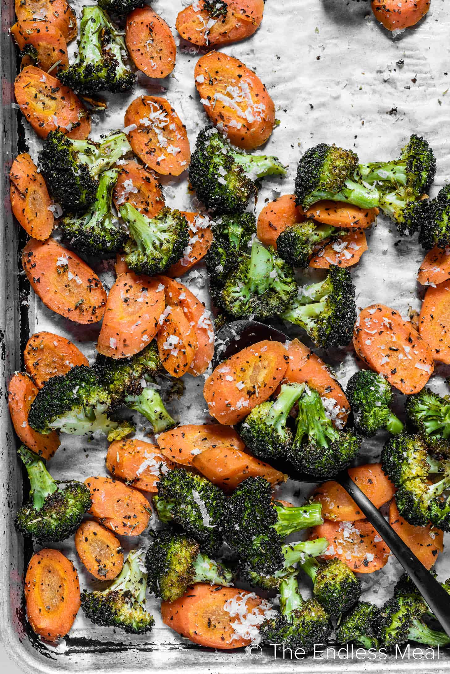 roasting broccoli and carrots on a baking sheet.