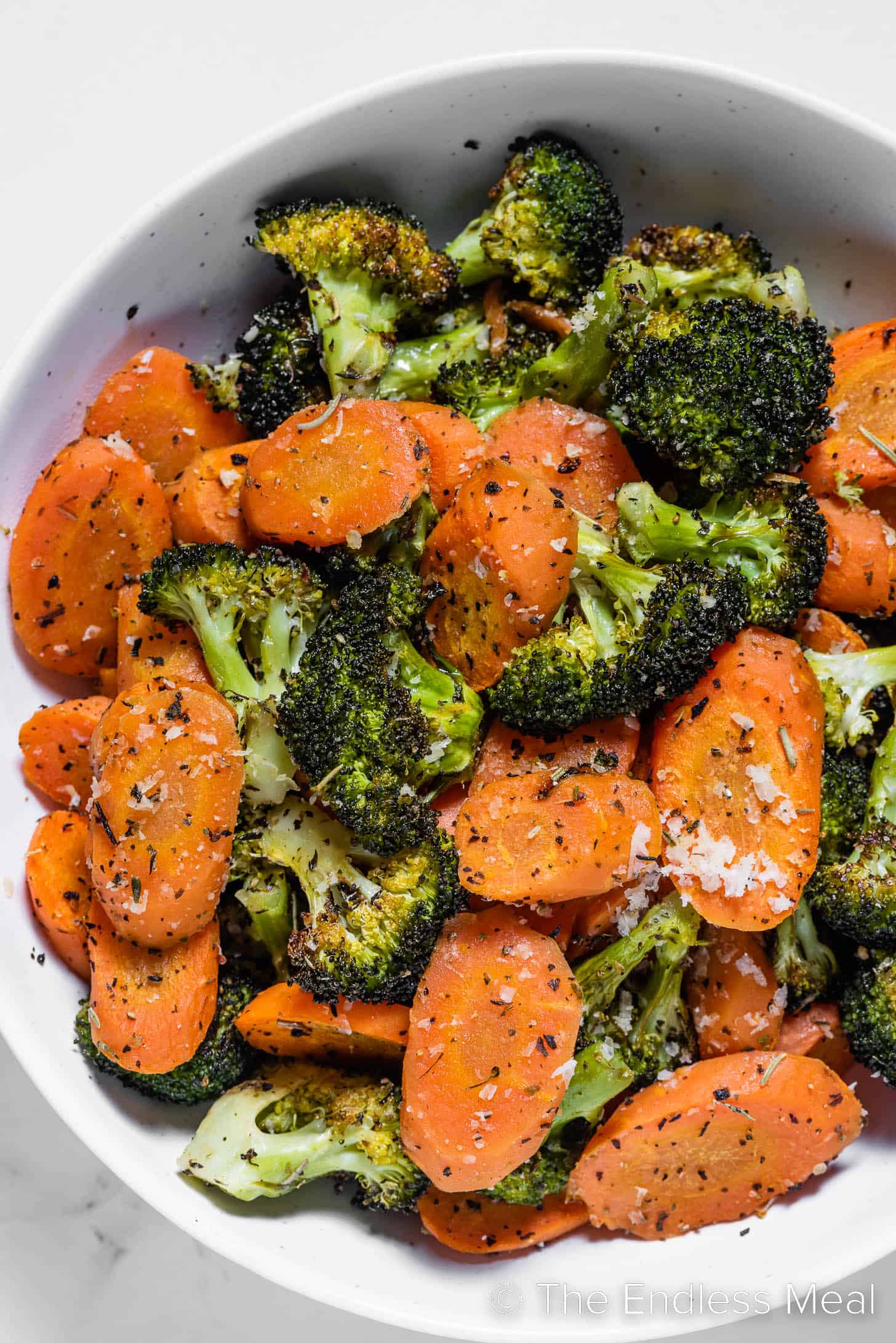 a close up of Roasted Broccoli and Carrots in a serving bowl