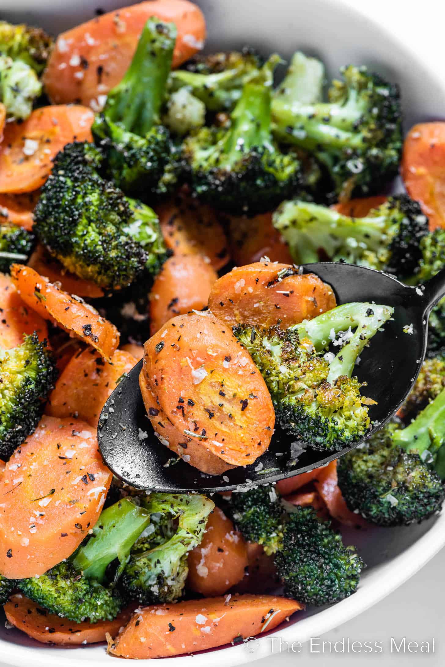 a close up of roasted broccoli and carrots.