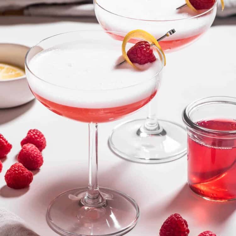 Two Clover Club Cocktail with raspberries