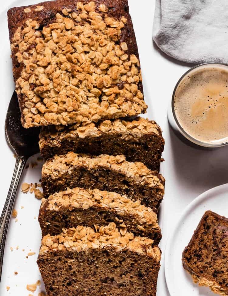 Slices of Coffee Banana Bread with streusel topping next to a cup of coffee